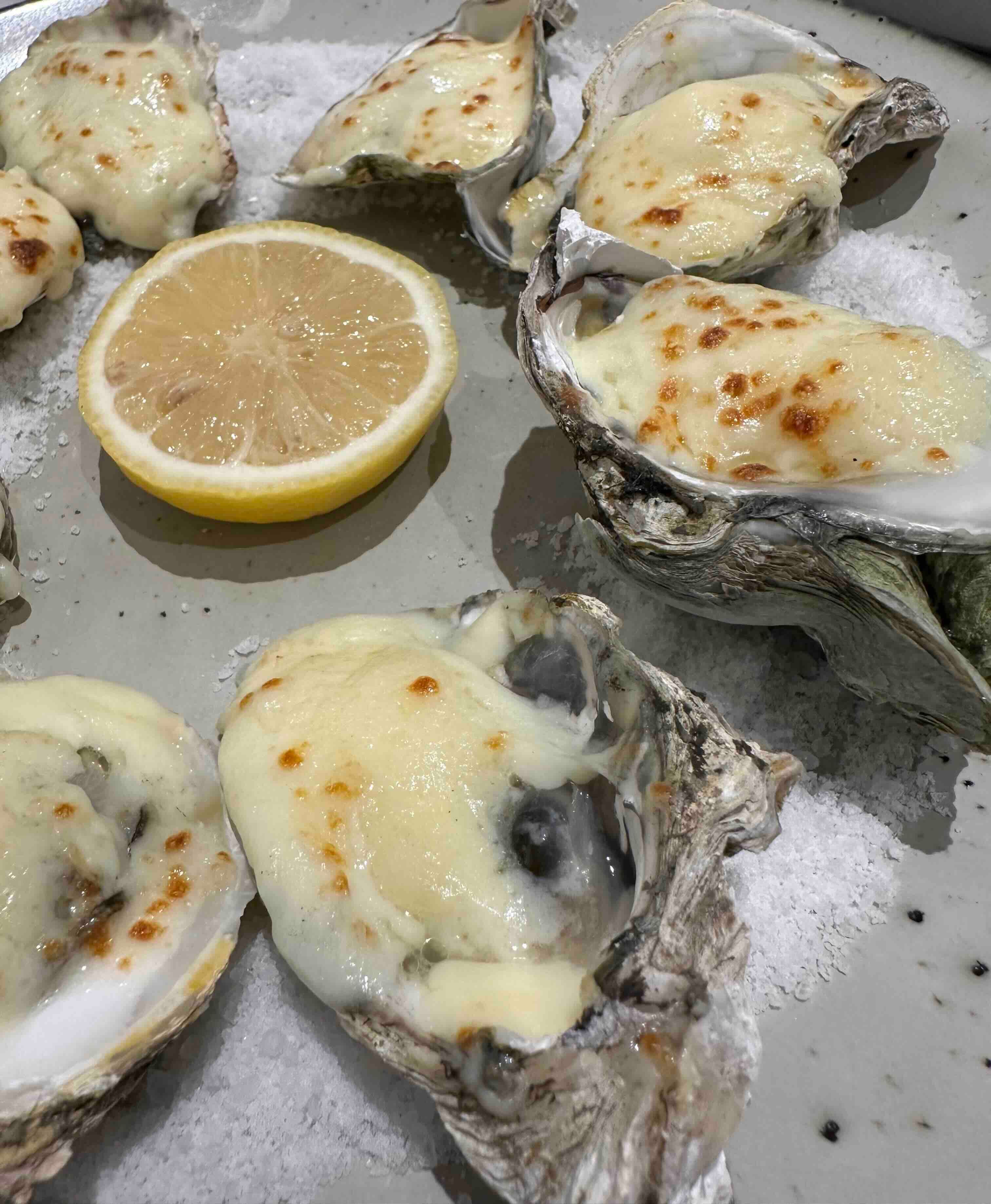 Baked oysters with gratineed cheese at Sourdough Cafe